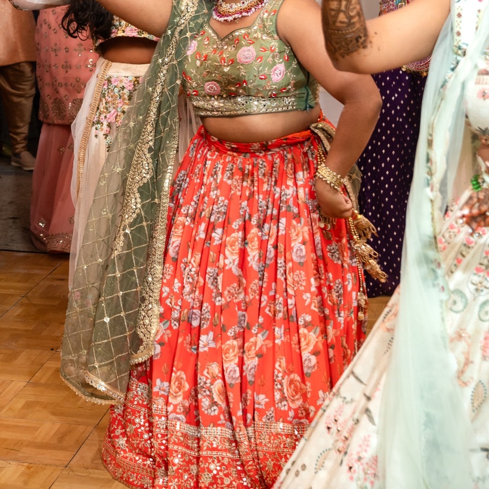 Vibrant orange and green Lehenga Choli